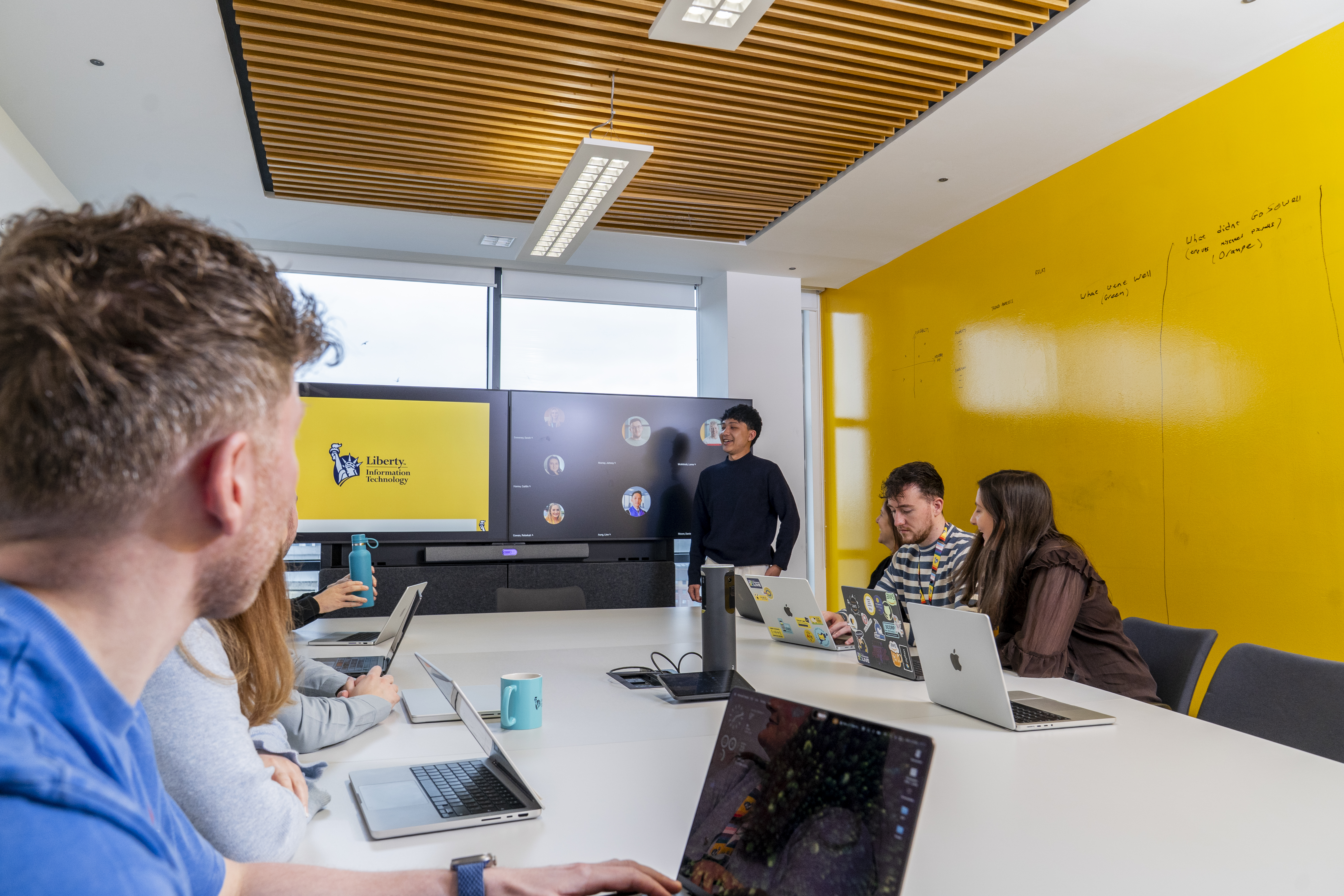 A meeting with one employee presenting to their team 