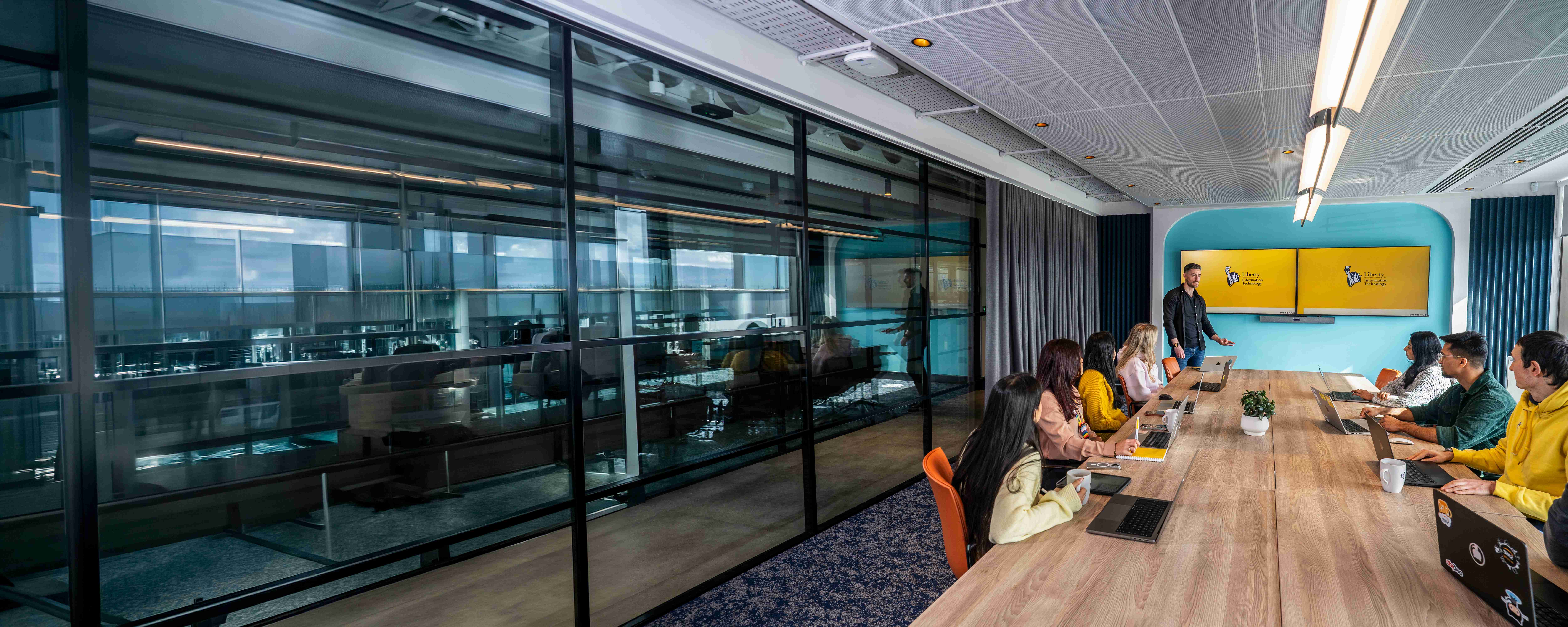 Employees working together in a Liberty IT office