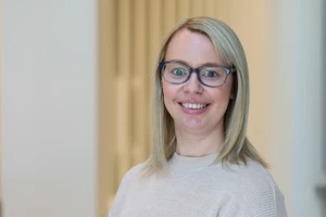 Clare, Engineering Manager, smiling in the office
