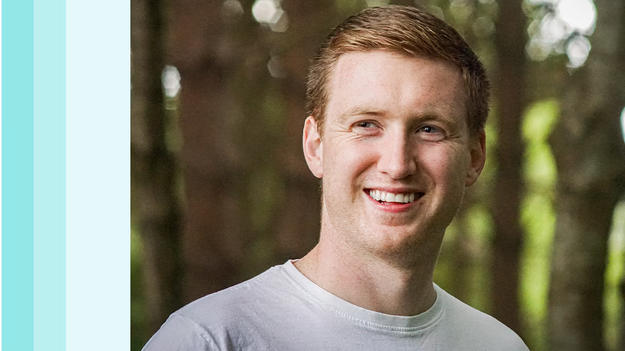 Dan, Data Scientist, smiling in a forest setting