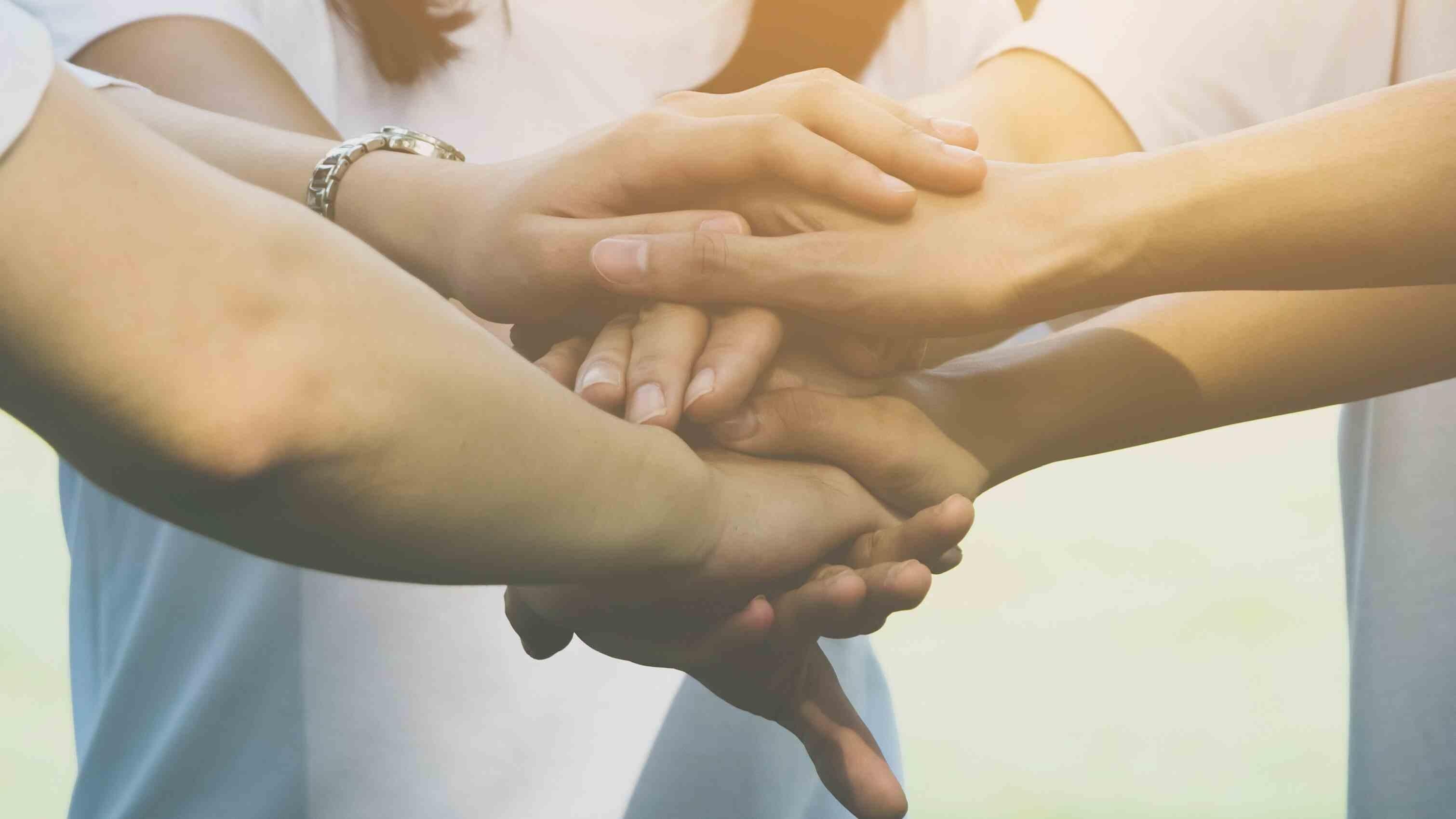 Photo of a number of hands on top of each other